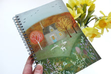 Load image into Gallery viewer, Hare notebook being held with daffodils in background
