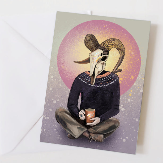 Aries card - person sitting cross legged wearing a rams skull
