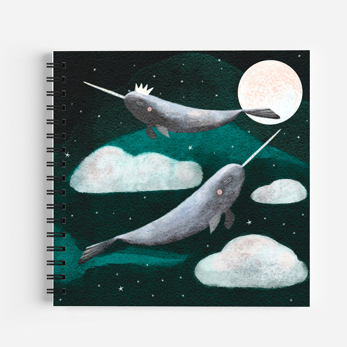 Narwhal notebook. Two narwhals flying in the sky